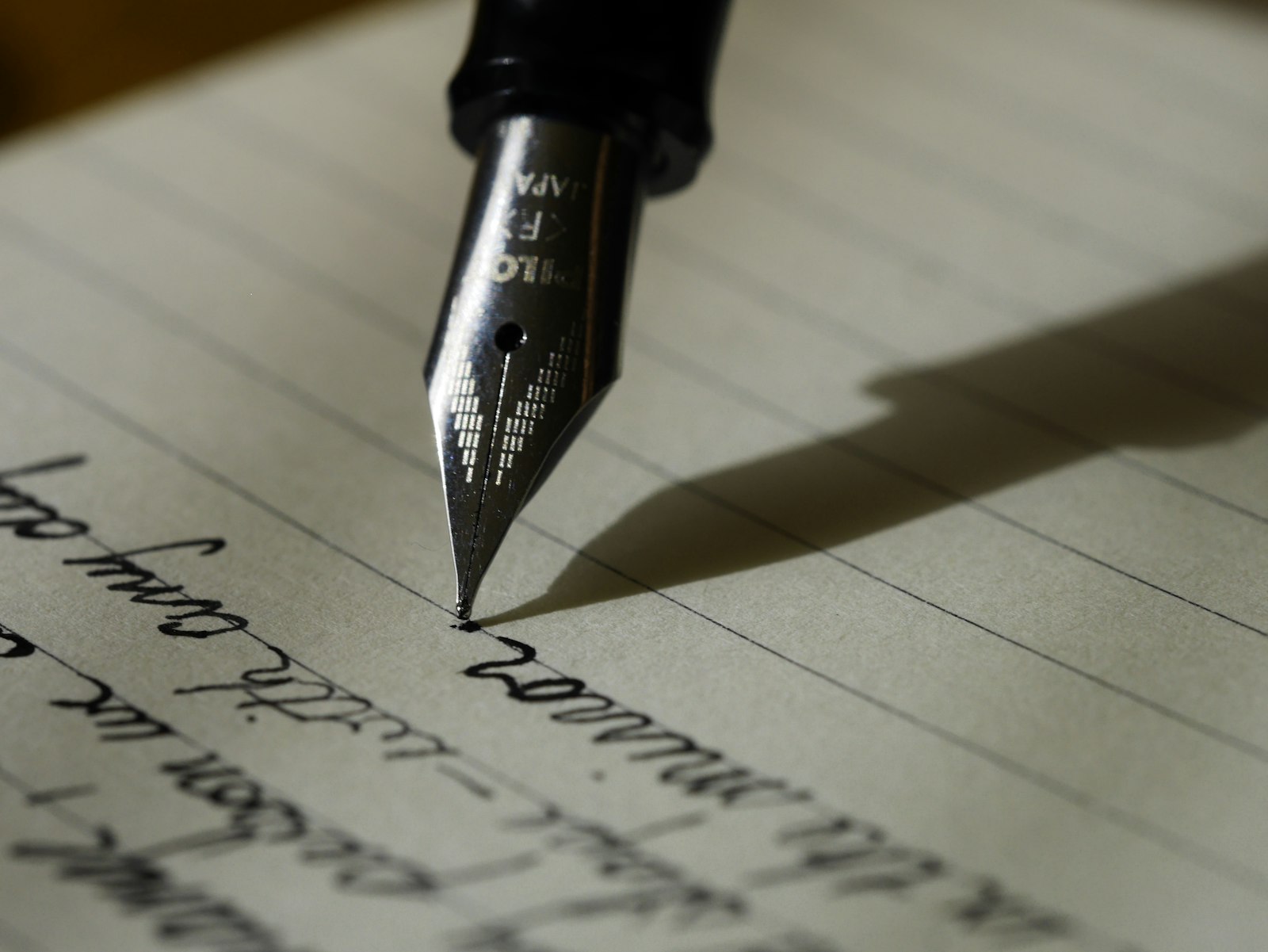 Open notebook and pen on a wooden desk