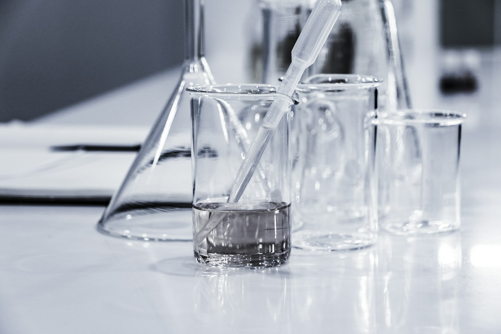 Laboratory glassware and science textbooks on a workbench